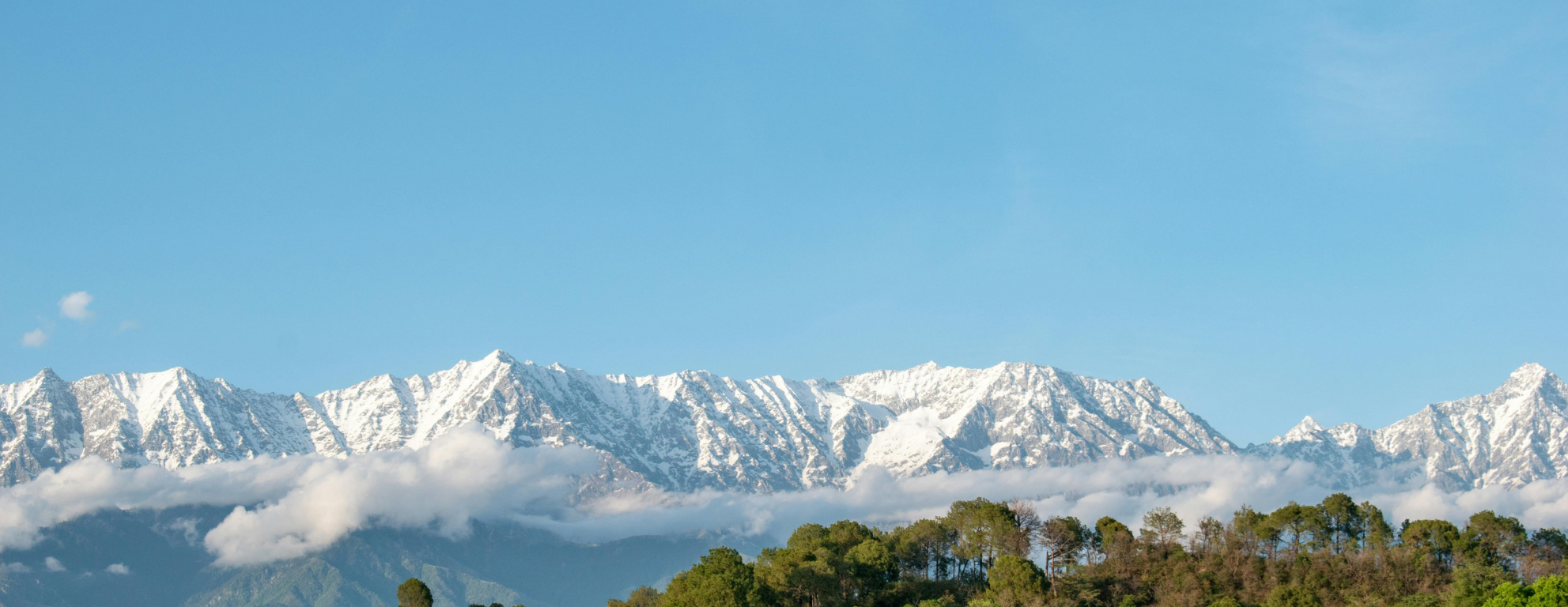 Snow-capped Dhauladhar mountain range and clouds in the Kangra Valley near Dharamshala, Himachal Pradesh.
