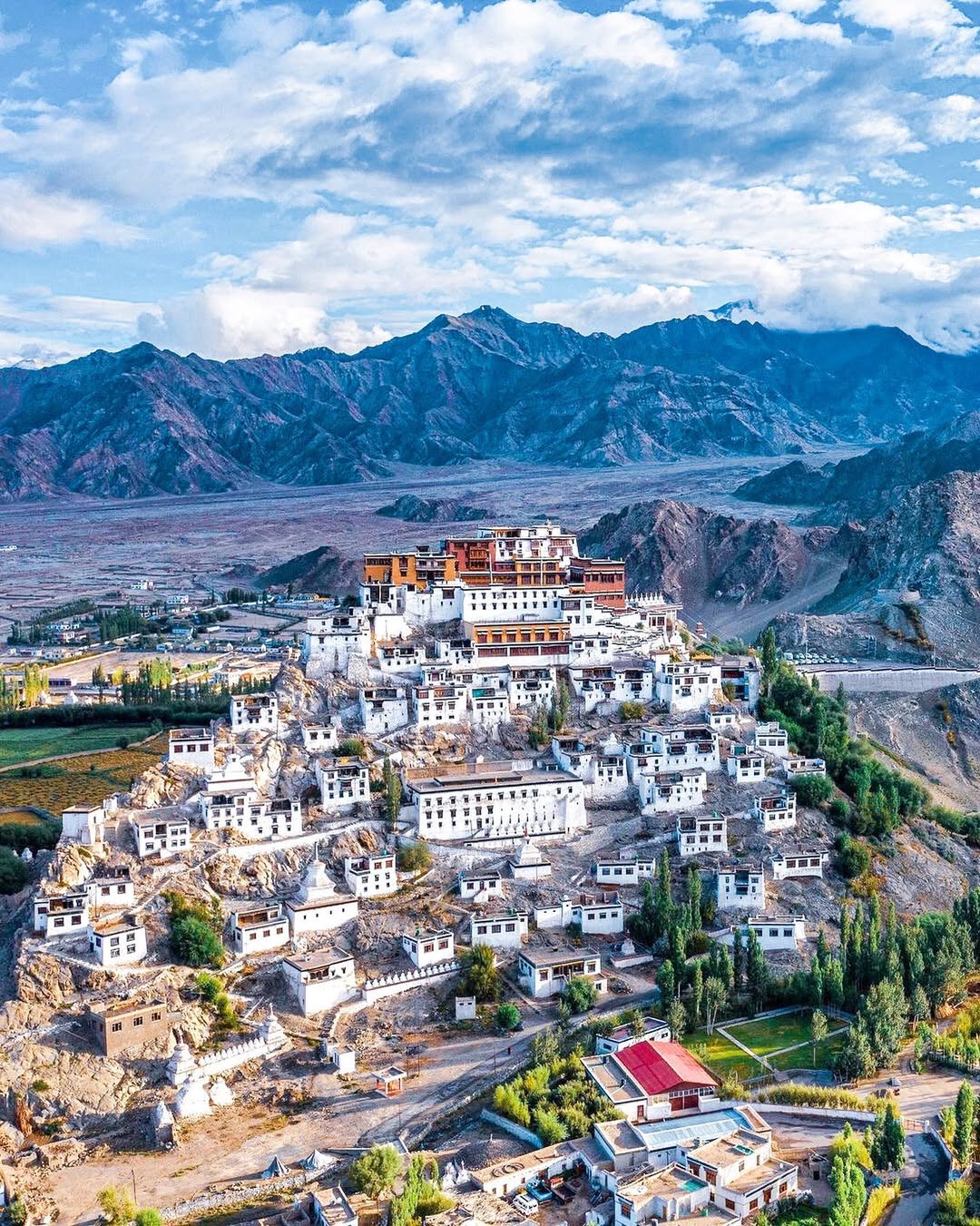 Panoramic view of the historic Leh Palace nestled in the rugged mountains of Ladakh.